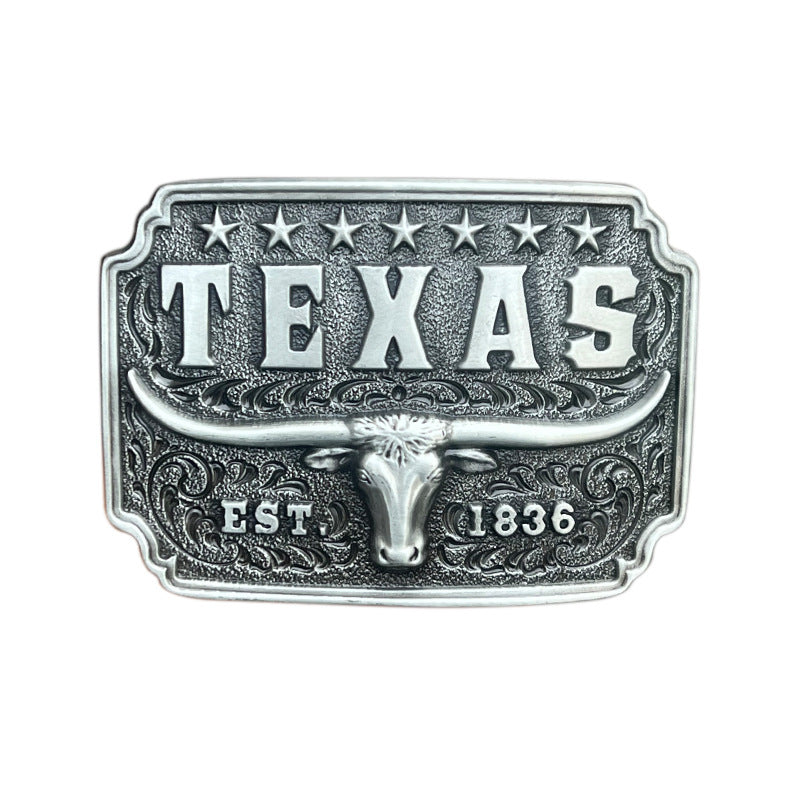 Silver western belt buckle with longhorn bull, 1836 engraving, and seven stars symbolizing Texas pride.