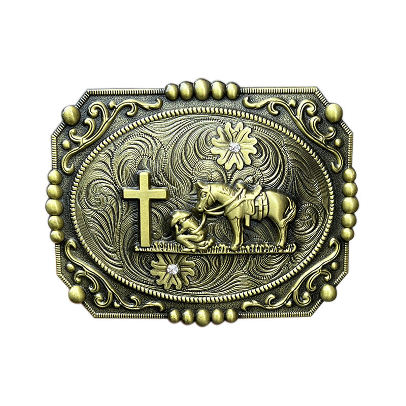 Bronze cowboy prayer belt buckle featuring a kneeling cowboy with horse beside a cross in western faith style.