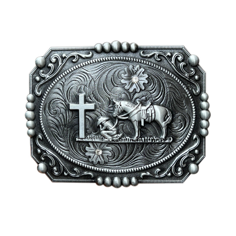 Silver cowboy prayer belt buckle with detailed engraving of cowboy kneeling at a cross with his horse.