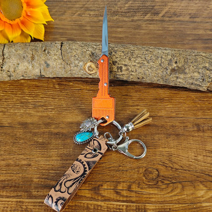 Red cowboy-style keychain with Western engraving

